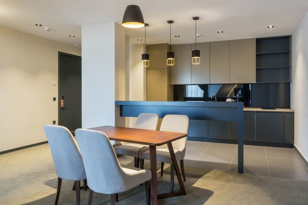 Large format tile flooring in a contemporary kitchen and dining space built for moisture resistant performance